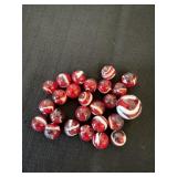 Group of red marbles with white stripes