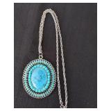 Silver colored chain with three inch pendant