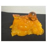 6ï¿½ HOULU amber-colored resin statue reclining