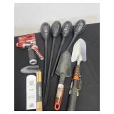 Group of yard tools and solar lights.