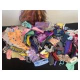 Group of Barbie clothes and doll head