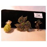 Gold tone pins with Various green colored stones