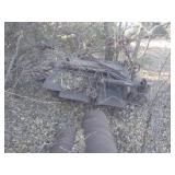 scrap metal under trees, hay bine