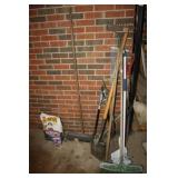 Yard tools, brooms, charcoal in patio room