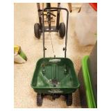 Yard Spreader and Bag of Fertilizer