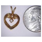 Pendant. Gold color. Clear stone. 1.2 gr