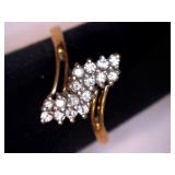 Gold tone ring. Multiple clear stones