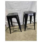 2 black metal backless bar stools, stackable