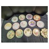 14 hand painted porcelain items; 12 plates, 1 tray