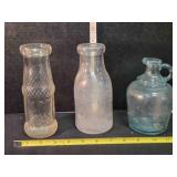3 clear glass bottles, 2 @ 7" tall, 6" tall