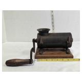 Antique cast iron tobacco shredder on wooden base