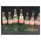 Coca Cola Bottles; (7); Green Glass-5; Clear-2