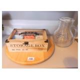 Tea container with tea packets and glass pitcher