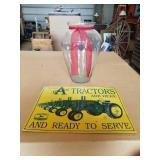 Metal tractor sign and vase