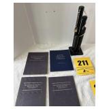 4 coin books and a coin bank