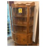 Oak bowfront China cabinet with four bottom doors