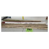 Large stack of walking sticks advertisement