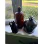 Stoneware jugs and amber glass jar