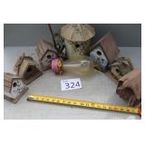 Seven Hanging Bird Houses and One Feeder