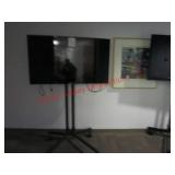 Samsung TV on black metal stand