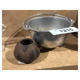 small metal cauldron and small clay pottery