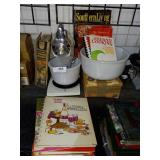 Assorted cookbooks mixing bowls and Sunbeam