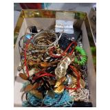 Assorted box of jewelry.