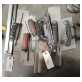 Seven concrete trowels