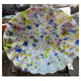 Decorative glass bowl with a scalloped edge and a