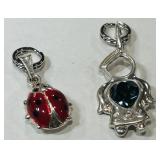 A PAIR OF STERLING SILVER PENDANTS