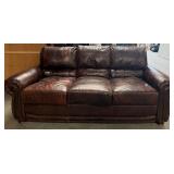11 - THREE-CUSHION LEATHER SOFA