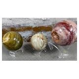 11 - THREE POLISHED STONE ORBS WITH DISPLAY (P36)