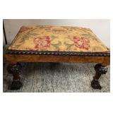 513 - UPHOLSTERED OTTOMAN W/ CARVED WOOD LEGS