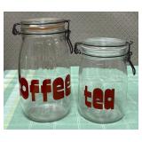 513 - TWO GLASS STORAGE JARS W/ WIRE CLASPS (M35)