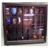 11 - COLLECTION OF SHOT GLASSES IN DISPLAY (C41)