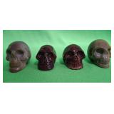 548 - FOUR CARVED SKULLS (A13)