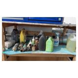 Shelf of assorted silicone, paints oils, etc.