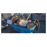 Two horse troughs full of miscellaneous
