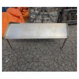 Stainless steel shelving from top of a cooler or