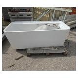 Acrylic bathtub with some damage on one side