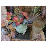 Sculpted shell on candle stick, artificial plant