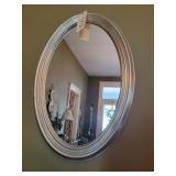Oval silver colored mirror