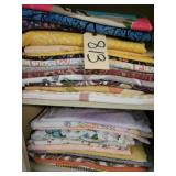 5 shelf of assortment of fabrics