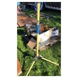 Yellow tripod, pick ax, and pipe bender