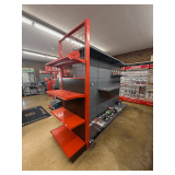 Freestanding Gondola Display Shelving: 3 Double-Sided Sections, Gray Pegboard with Red End Cap, Peg Hooks, and Shelves