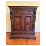 Ornately Carved Wooden Cabinet With Drawer and Doo