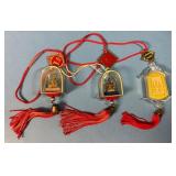 Three Buddhist Amulets With Red Cords and Tassels