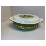 Pyrex olive green oval 2.5 qt. casserole dish featuring the 'Spring Blossom' or 'Crazy Daisy' pattern