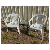 Two White Plastic Armchairs and One Folding Glass-Top Side Table