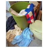Plastic waste can containing various linens